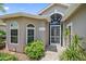 The front entrance is enhanced by a large arched window, a decorative security door and custom brick at 4330 Beekman Pl # 103, Sarasota, FL 34235