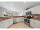 Well-lit kitchen with granite countertops, stainless steel appliances, and a view of the backyard at 4330 Beekman Pl # 103, Sarasota, FL 34235