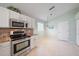 Kitchen featuring stainless steel oven and microwave, granite counters, and tiled flooring at 4330 Beekman Pl # 103, Sarasota, FL 34235