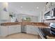 Kitchen with granite countertops, stainless steel appliances, and a view into the adjacent living area at 4330 Beekman Pl # 103, Sarasota, FL 34235