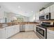 Bright kitchen featuring stainless steel appliances, granite countertops, and ample cabinet space at 4330 Beekman Pl # 103, Sarasota, FL 34235