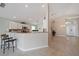 Bright open-concept kitchen and entryway with granite countertops and stainless steel appliances at 4330 Beekman Pl # 103, Sarasota, FL 34235