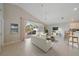 A bright living room features an open concept with a kitchen bar and access to a screened lanai at 4330 Beekman Pl # 103, Sarasota, FL 34235