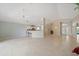 Open floor plan featuring tile floors, a breakfast bar, and a view of the entryway with double doors at 4330 Beekman Pl # 103, Sarasota, FL 34235