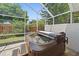 Relax in this screened-in lanai with a spa, tile pavers, and a ceiling fan at 4330 Beekman Pl # 103, Sarasota, FL 34235