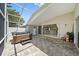This screened-in lanai features a spa, pavers, and an open view of the kitchen at 4330 Beekman Pl # 103, Sarasota, FL 34235