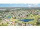 Wide aerial view of a community with golf courses, ponds, and many homes at 4330 Presidential Avenue E Cir, Bradenton, FL 34203