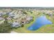 Aerial view of homes lining the golf course, a pond, and private pools at 4330 Presidential Avenue E Cir, Bradenton, FL 34203
