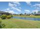 Lush backyard featuring a pond, and manicured lawn at 4330 Presidential Avenue E Cir, Bradenton, FL 34203