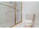 Bathroom featuring a shower with a gold trimmed sliding glass door and an adjacent toilet at 4330 Presidential Avenue E Cir, Bradenton, FL 34203