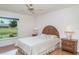 Bright bedroom with a ceiling fan, wood floors, and a backyard view at 4330 Presidential Avenue E Cir, Bradenton, FL 34203
