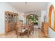Elegant dining room features a large window, glass-top table and a stylish china cabinet at 4330 Presidential Avenue E Cir, Bradenton, FL 34203