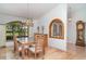 This dining room includes a chandelier, a hutch, and a striking arched entry-way at 4330 Presidential Avenue E Cir, Bradenton, FL 34203