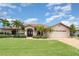 Charming single-story home with a well-manicured lawn, mature palm trees, and a spacious two-car garage at 4330 Presidential Avenue E Cir, Bradenton, FL 34203