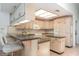 Spacious eat-in kitchen offers light-colored cabinets, black countertops, and an adjacent breakfast bar at 4330 Presidential Avenue E Cir, Bradenton, FL 34203