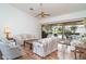 Bright living room with hardwood floors, comfortable seating, and sliding glass doors leading to the pool area at 4330 Presidential Avenue E Cir, Bradenton, FL 34203