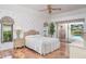 Relaxing main bedroom with a ceiling fan, a view of the pool and a small wet bar at 4330 Presidential Avenue E Cir, Bradenton, FL 34203