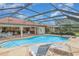 Relaxing screened-in pool area with a spa, lounge chairs, and outdoor dining space, perfect for enjoying sunny days at 4330 Presidential Avenue E Cir, Bradenton, FL 34203