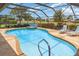 Sparkling pool with a jacuzzi and chairs with a view of the pond and golf course at 4330 Presidential Avenue E Cir, Bradenton, FL 34203