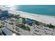 An aerial view highlights Lido Beach with ocean views, a lifeguard stand, beachgoers, and coastal charm at 444 S Polk Dr, Sarasota, FL 34236