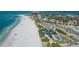 Aerial view showcases Lido Beach's shoreline, sandy beach, coastal greenery, and blue Pavilion, creating a coastal vibe at 444 S Polk Dr, Sarasota, FL 34236