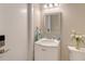Cozy bathroom featuring a vanity with a marble countertop, stylish mirror, and decorative accents at 444 S Polk Dr, Sarasota, FL 34236