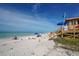 Picturesque beach scene with clear skies, blue ocean, a lifeguard station, and people enjoying the scenery at 444 S Polk Dr, Sarasota, FL 34236
