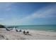 Picturesque beach scene featuring sunbathers, clear waters, and gentle waves lapping the shore, creating a relaxing atmosphere at 444 S Polk Dr, Sarasota, FL 34236
