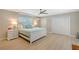 Bright bedroom with light-colored furniture, a ceiling fan, and plenty of closet space at 444 S Polk Dr, Sarasota, FL 34236