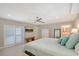 Bright and airy bedroom featuring plantation shutters, ceiling fan, and access to an en-suite bathroom at 444 S Polk Dr, Sarasota, FL 34236