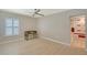 Bright bedroom featuring a ceiling fan, light wood floors and an adjacent bathroom entrance at 444 S Polk Dr, Sarasota, FL 34236