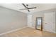 Bedroom with neutral walls, light wood flooring, a large mirror and two doors at 444 S Polk Dr, Sarasota, FL 34236