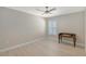 Bedroom with light wood flooring, white trim, neutral paint and a shuttered window at 444 S Polk Dr, Sarasota, FL 34236