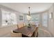 Bright dining room featuring stylish furniture, natural light, and an open view to the updated kitchen at 444 S Polk Dr, Sarasota, FL 34236
