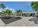 Lovely home showcasing beautiful landscaping, a paver driveway, and a carport at 444 S Polk Dr, Sarasota, FL 34236
