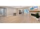 Spacious living room with fireplace, light wood floors, and sliding glass doors to the pool at 444 S Polk Dr, Sarasota, FL 34236
