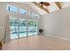 Spacious living room with high ceilings, clerestory windows, wood beams, and a view of the pool at 444 S Polk Dr, Sarasota, FL 34236