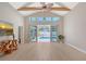 Open living area with high ceilings, clerestory windows, wood beams, and a view of the pool at 444 S Polk Dr, Sarasota, FL 34236