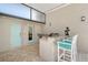 Outdoor kitchen area with bar seating and stainless steel barbeque at 444 S Polk Dr, Sarasota, FL 34236