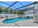 Beautiful screened-in pool area with a spa, outdoor seating and privacy fencing at 444 S Polk Dr, Sarasota, FL 34236