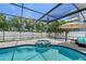Enclosed outdoor pool area with a spa, seating and privacy wall at 444 S Polk Dr, Sarasota, FL 34236