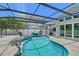 Beautiful pool area enclosed with screened in protection, palms and room for furniture at 444 S Polk Dr, Sarasota, FL 34236