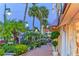 Picturesque sidewalk with lush landscaping, potted plants, and storefronts at 444 S Polk Dr, Sarasota, FL 34236