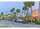 Scenic street view with palm trees, storefronts, and parked cars at twilight at 444 S Polk Dr, Sarasota, FL 34236