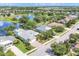 Aerial view of a neighborhood with well-kept lawns, mature trees, and a serene lake at 4714 Seneca Park Trl, Bradenton, FL 34211
