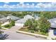 Aerial view of a well-manicured home with mature trees, lush landscaping, and a water view at 4714 Seneca Park Trl, Bradenton, FL 34211