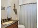 Well-lit bathroom with a dark vanity, granite countertop, and a decorative mermaid statue at 4714 Seneca Park Trl, Bradenton, FL 34211