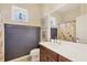 Charming bathroom boasts decorative wall trim, a framed mirror, and vanity with storage at 4714 Seneca Park Trl, Bradenton, FL 34211