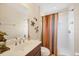 Well-lit bathroom with a shower, decorative accents, and a vanity with storage at 4714 Seneca Park Trl, Bradenton, FL 34211