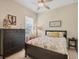 Cozy bedroom features a ceiling fan, natural light, and tasteful decorations at 4714 Seneca Park Trl, Bradenton, FL 34211